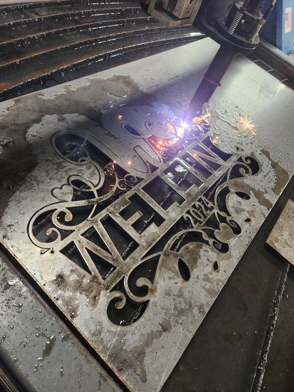 CNC plasma cutting the W Scroll Heart Monogram design